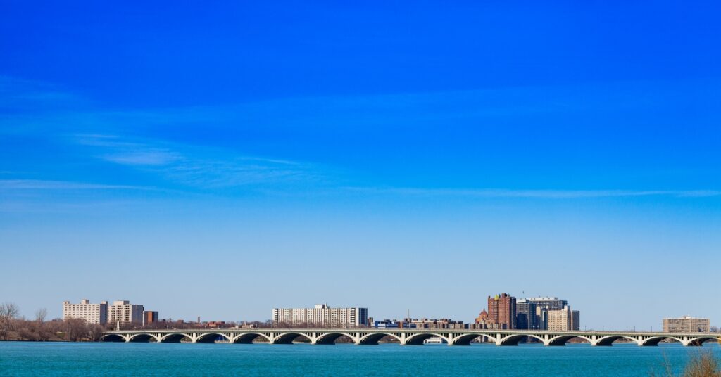 Douglas MacArthur Bridge over Detroit river and city view on sunny day from sunset point of Belle Isle.