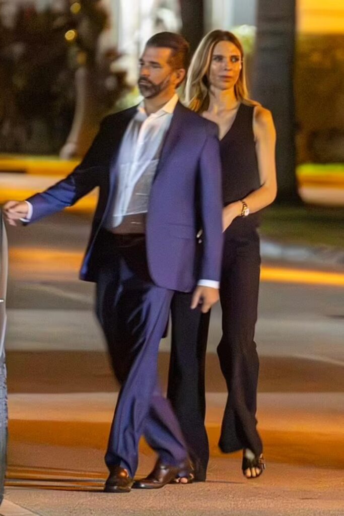 Donald Trump Jr. and Bettina Anderson walking hand in hand in Palm Beach